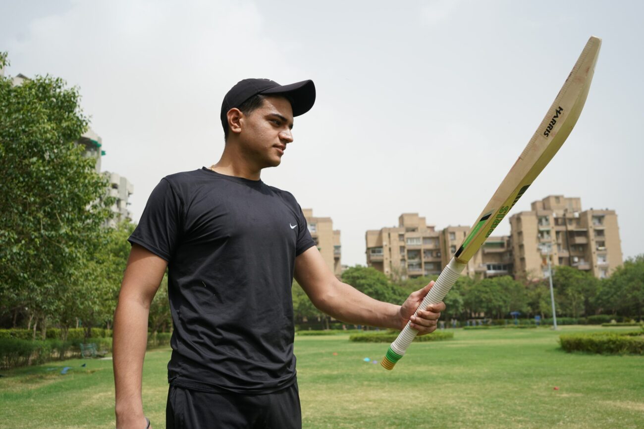 One guy stand out on ground with holding bat in hand